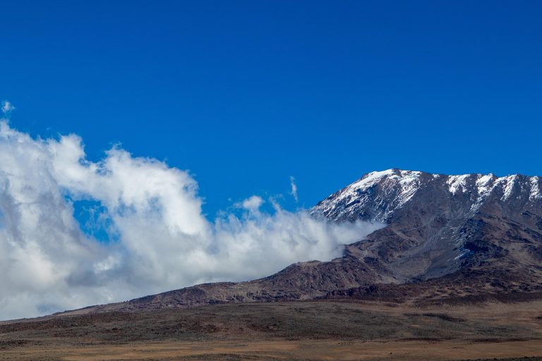 Trekkers on the Lemosho route of Mount Kilimanjaro with the Kibo summit dome ahead